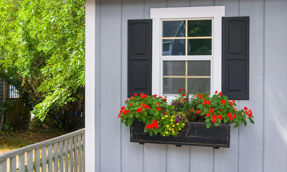 Cottage-inspired Brick Porch with Flower Boxes and Hanging Baskets